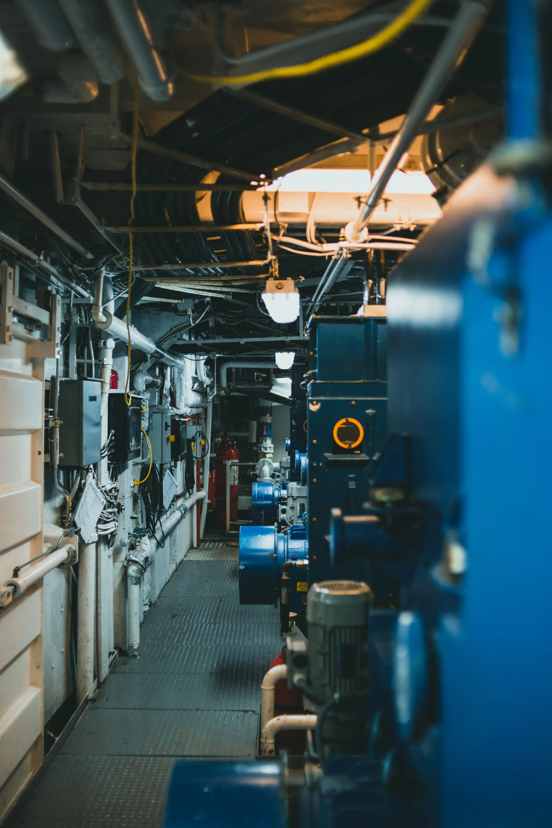 Industrial boiler plant room with pipework, pumps and gauges