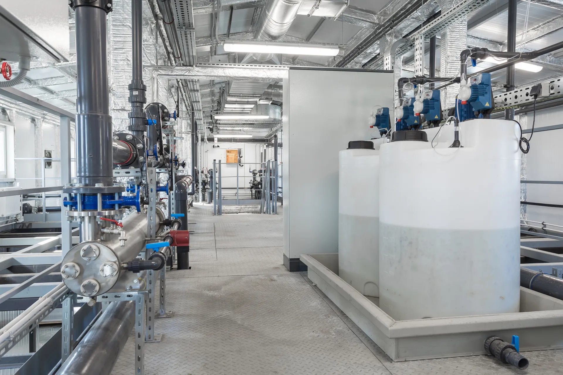 Chemical dosing station with day tanks and metering pumps in a plant room