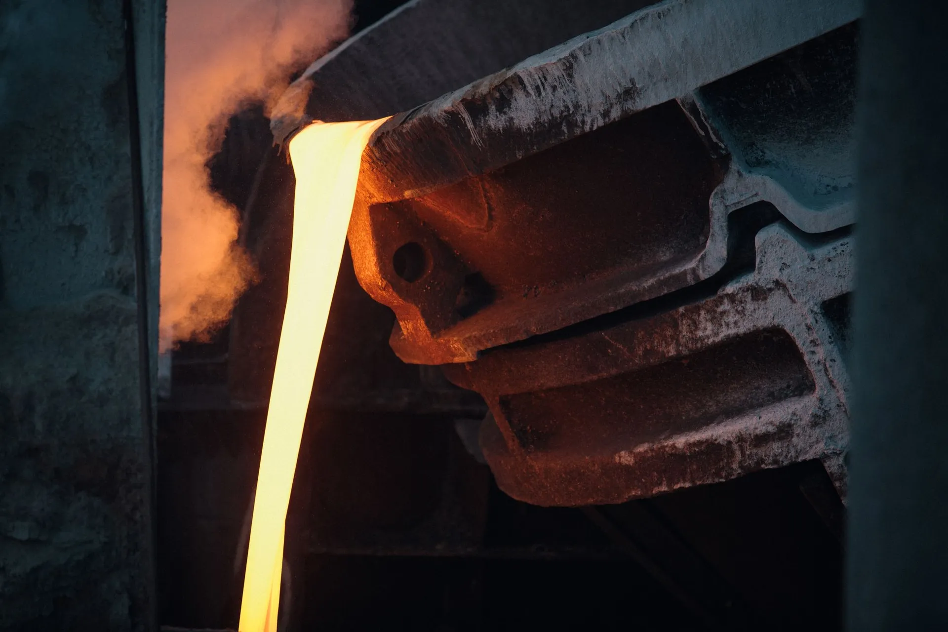 Molten metal pouring from a furnace at a smelter