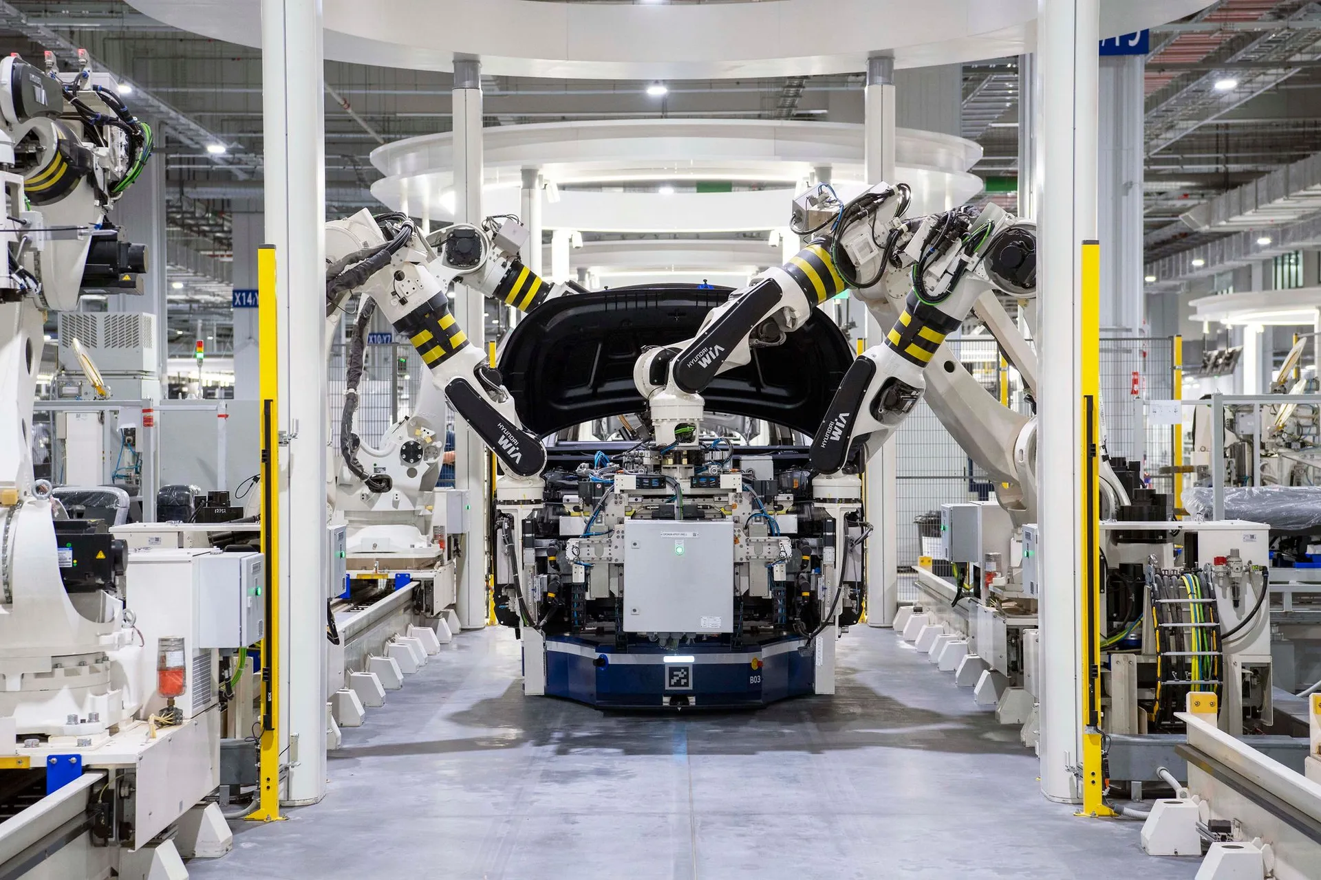Robotic arms assembling a car body on an automotive line