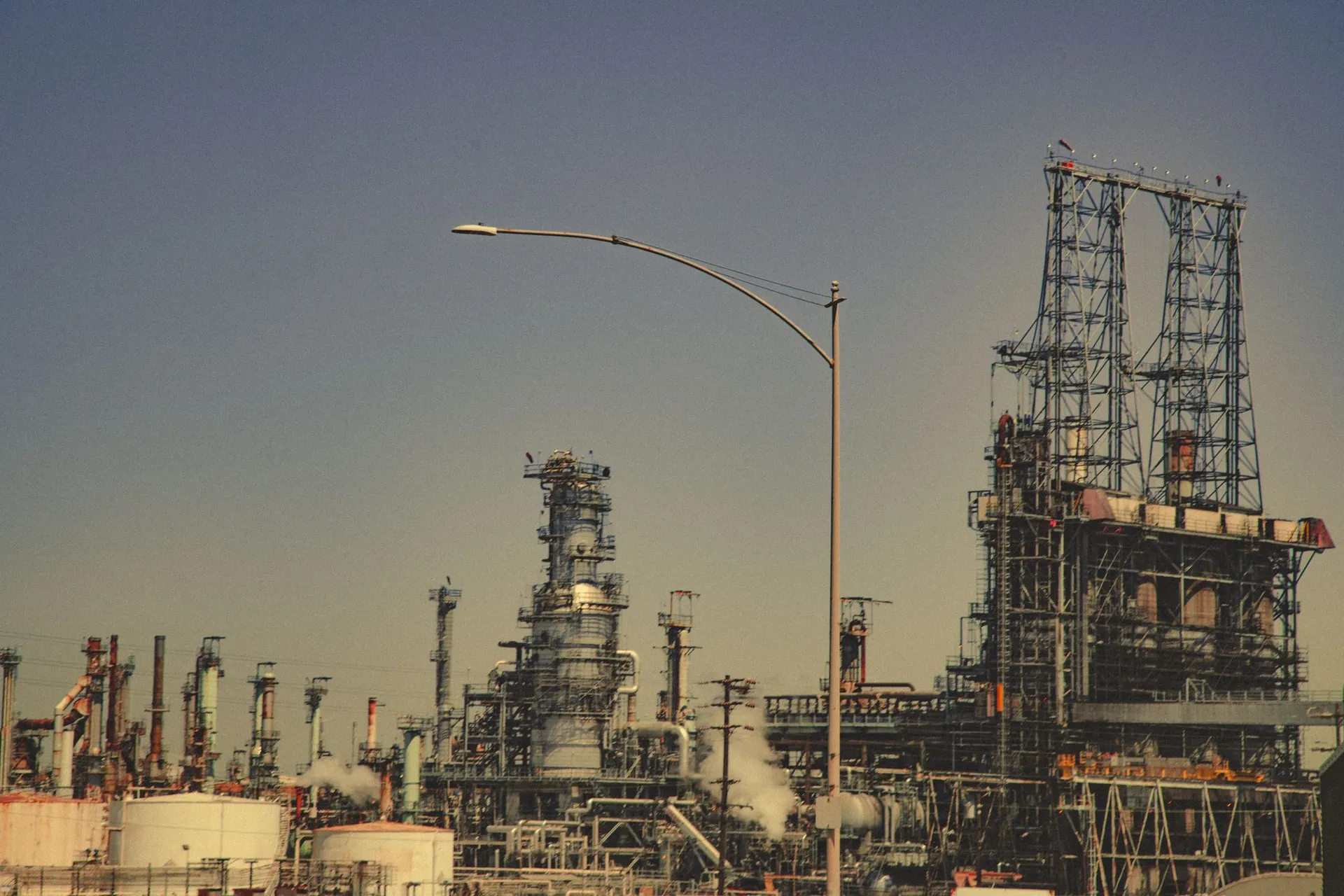 Oil and gas refinery with process towers at dusk