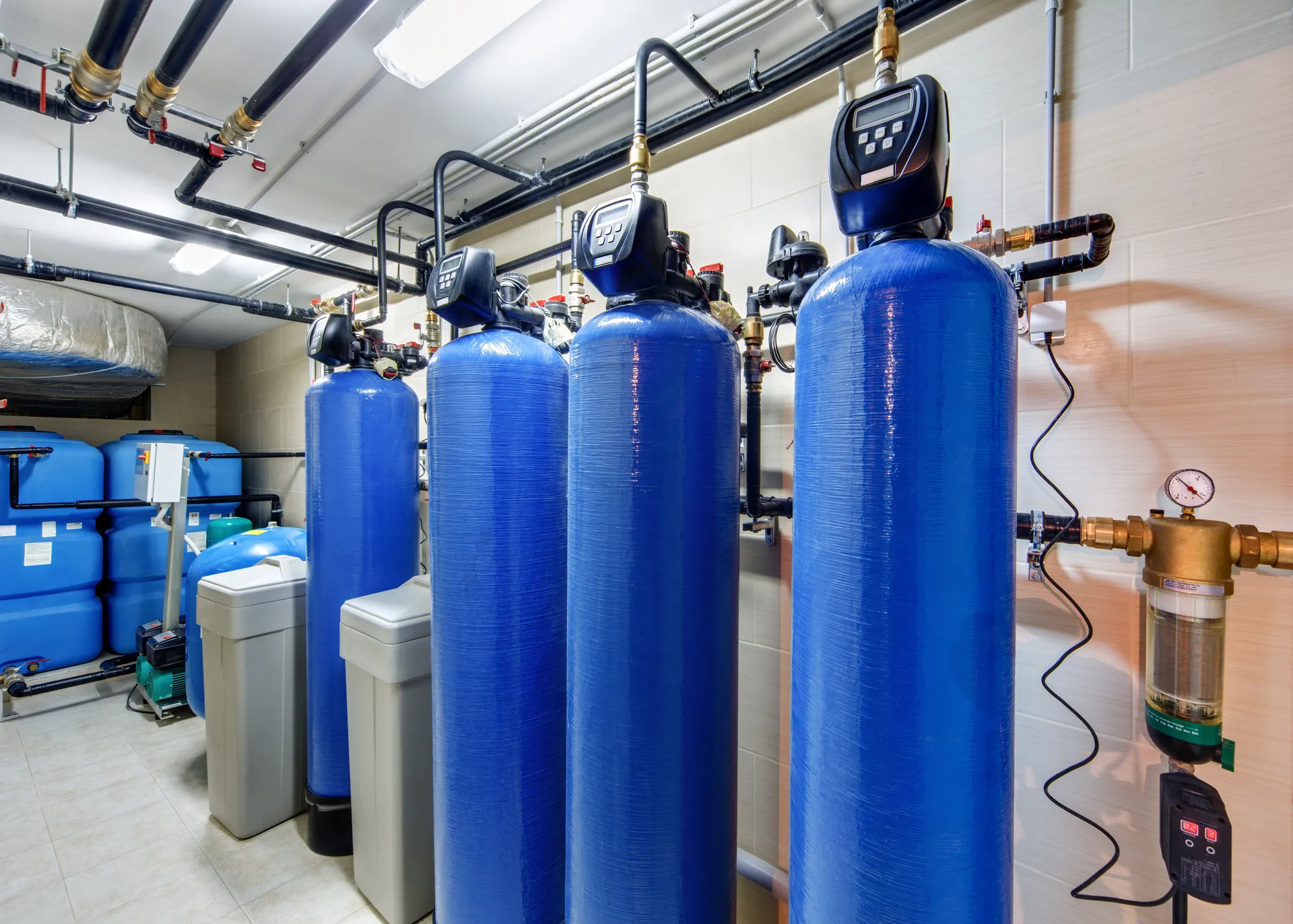 Compact packaged water treatment plant room with treatment vessels and storage tanks
